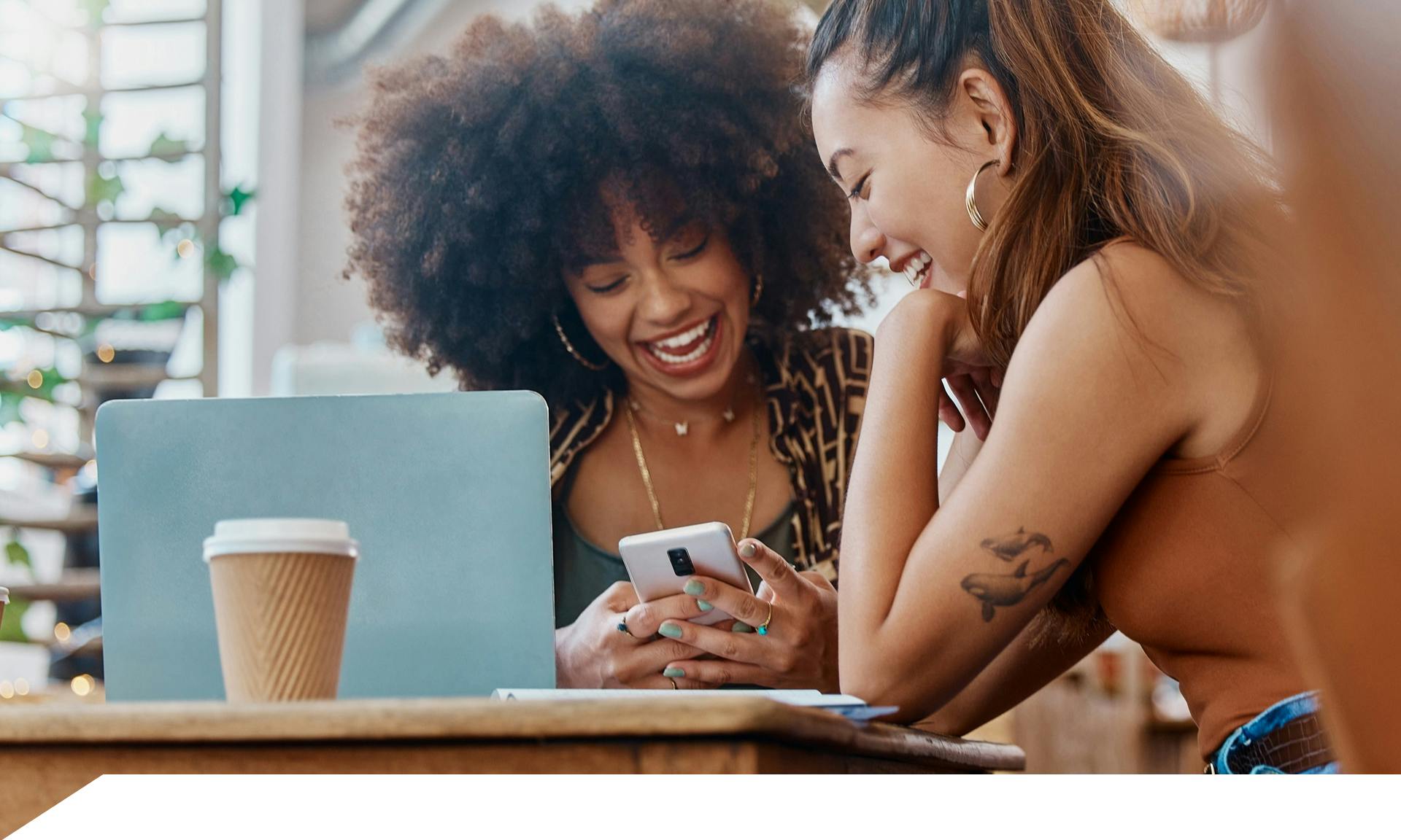 Two women looking at laptop