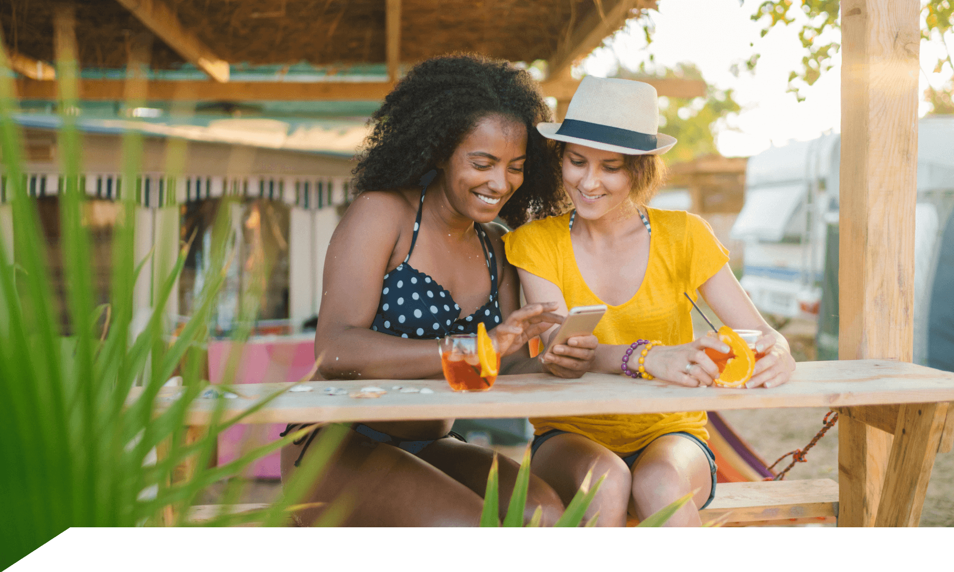 Two women traveling looking at smartphone
