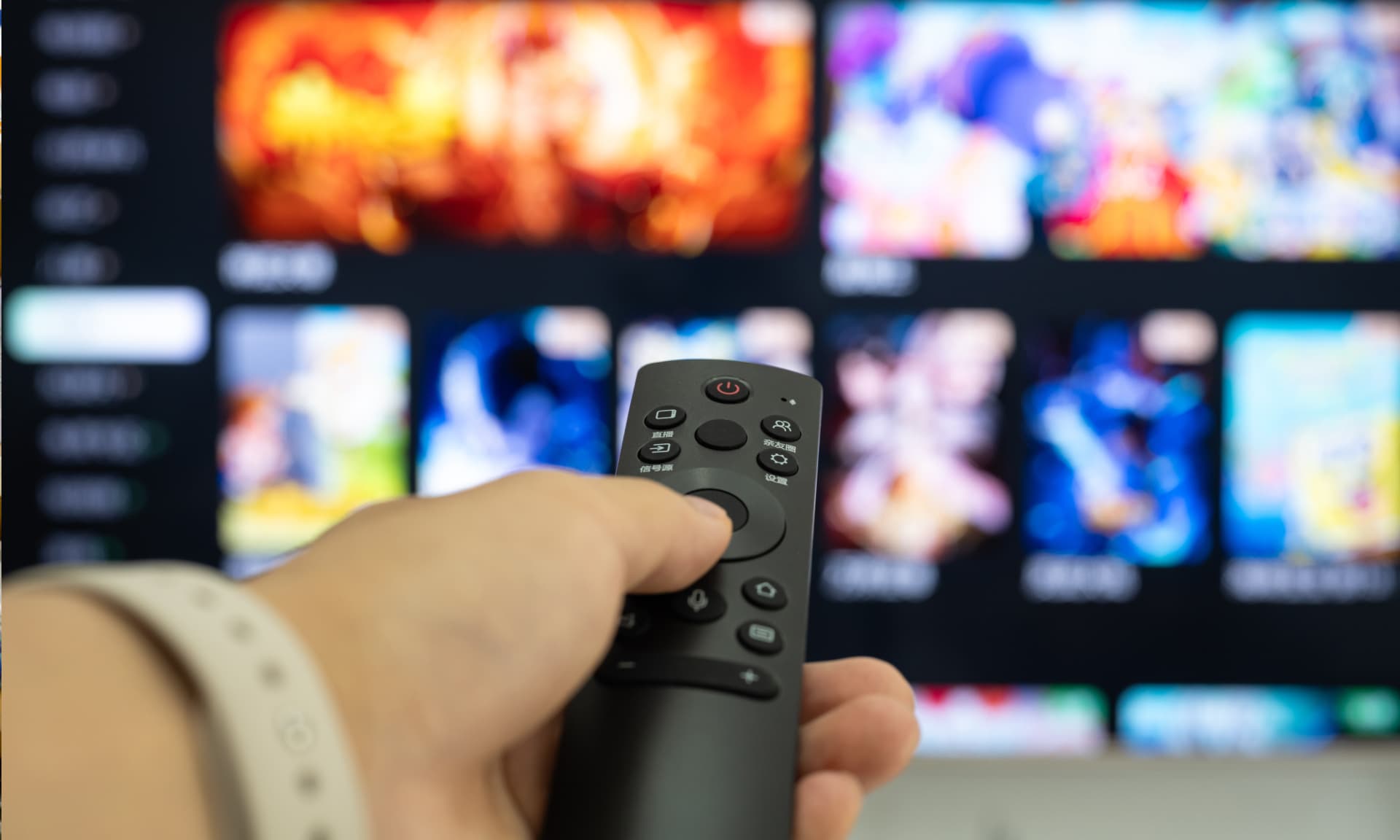 Someone using a remote to scroll TV