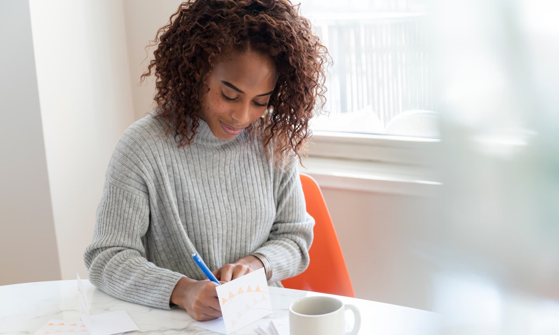 Woman writing a thank you note