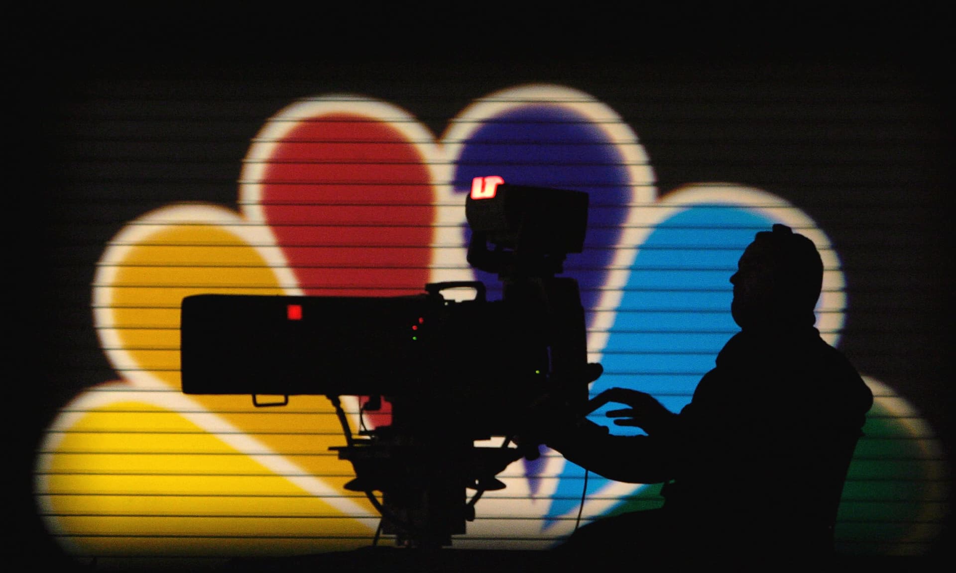 MSNBC Camera man in front of the peacock logo