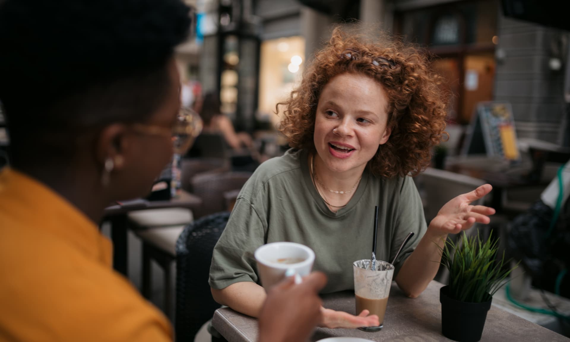 Two women chatting over coffee