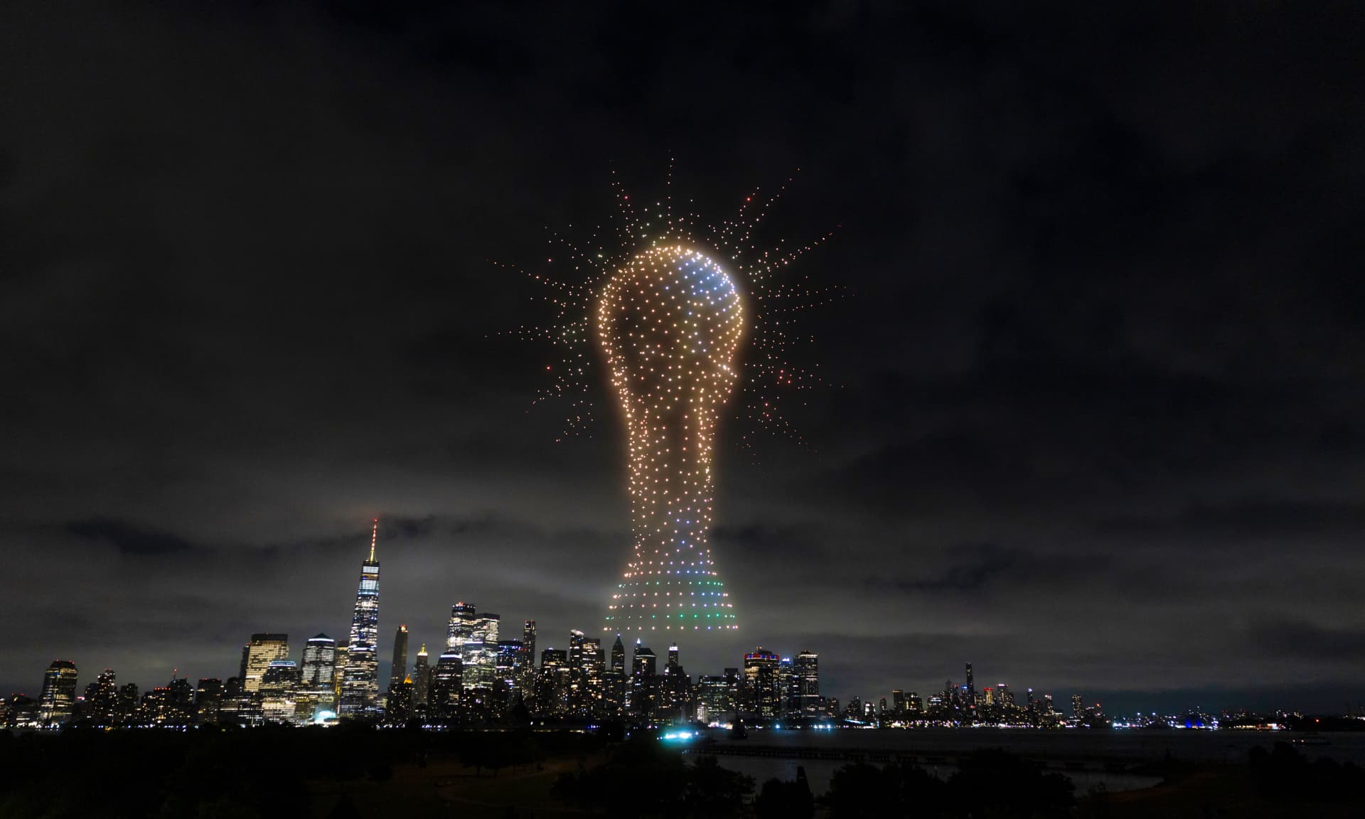 An image of the FIFA World Cup trophy is displayed against the Manhatten skyline